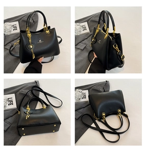 Detailed views of a black leather handbag with gold hardware and a heart pendant