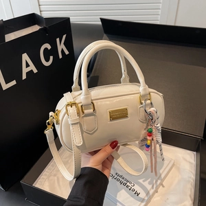 Weiße minimalistische Bowling-Handtasche mit goldener Plakette und Perlenanhänger