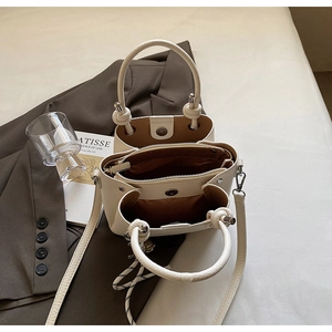 Detail of cream leather bag with brown fabric lining and interior zip compartment