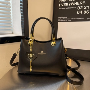 Fashionable black faux leather handbag for women with gold logo and heart charm
