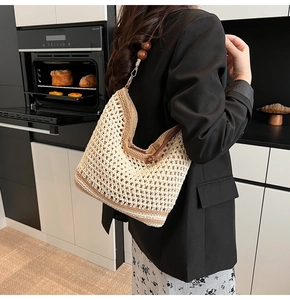 Detail of woven tote bag featuring decorative wood beads and textured hollow knit design