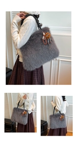 Detail of grey faux fur tote bag with black woven handles and brown plush ball charm