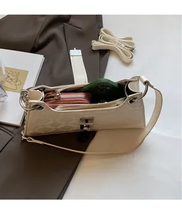 Interior view showing the large capacity of the beige baguette bag with daily essentials