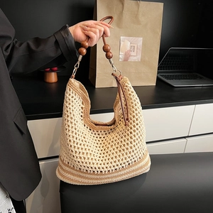 Hollow out woven hobo bag with leather straps and wooden beads for summer travel