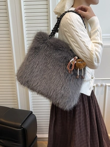 Faux fur plush tote bag in dark grey with black braided leather strap and fur ball charm
