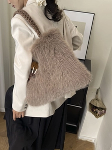 Furry light brown tote bag with woven handles shown in a lifestyle setting