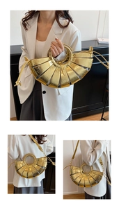 Détail macro du sac coquille doré en éventail avec poignée tressée et motif ajouré