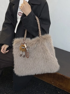 Light brown faux fur tote bag with woven handles and leopard print doll charm