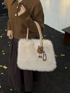 Beige faux fox fur tote bag with braided handles and a cute bear charm pendant