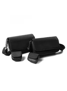 Detail of black Saffiano PU leather messenger bag set with wide woven straps