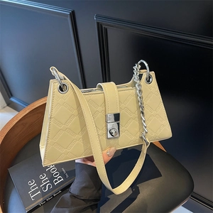 Creamy white underarm bag with geometric relief, silver lock, and metal chain strap