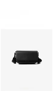 Front view of black PU leather messenger bag with crosshatch texture and adjustable strap