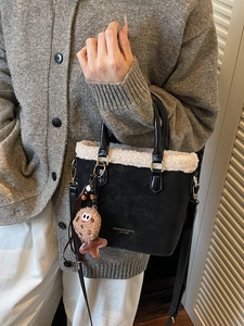 Sac seau noir chic avec bordure en peluche blanche et bandoulière longue réglable