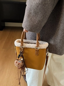 Sac seau jaune moutarde avec bordure en fausse fourrure blanche et poignées en cuir marron chic