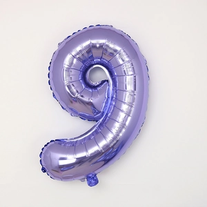 Close-up of a 30-inch purple foil number 9 balloon with metallic texture for party decor