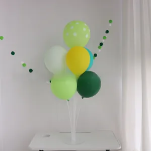 Close-up of green and yellow party balloon stand with polka dot patterns for birthday decor