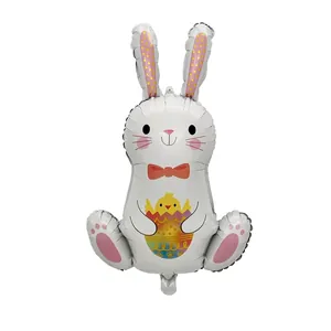 Easter sitting bunny foil balloon holding a colorful chick egg for party decoration