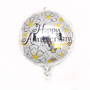 Detail of silver foil balloon with Happy Anniversary text and floral patterns