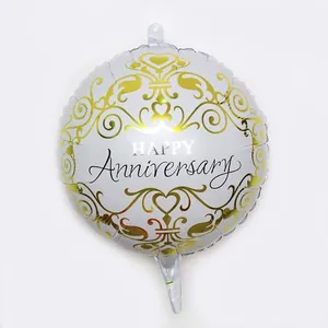 Detailed view of silver foil balloon with gold scroll patterns and Happy Anniversary text
