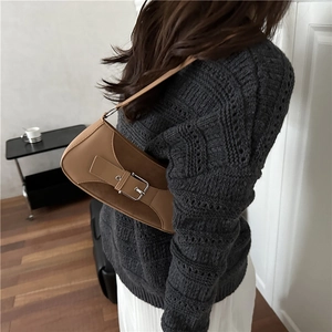 Retro camel leather underarm bag with metal buckle shown with a knitted sweater