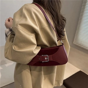 Retro dark red leather underarm bag with metal buckle shown on a female model