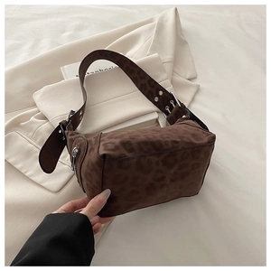 Brown leopard print shoulder bag detail with wide strap and silver eyelet accents