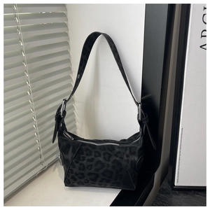 Detail of black leopard print hobo bag in suede texture with adjustable wide strap