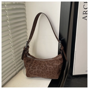 Detail of retro leopard print hobo bag with plush texture and silver metal zipper