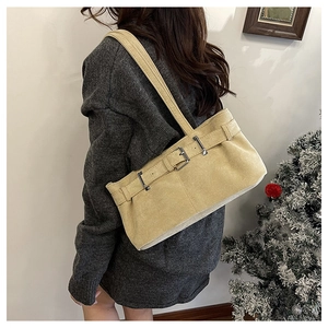Détail du sac à bandoulière en daim beige avec boucles argentées en décor d'hiver
