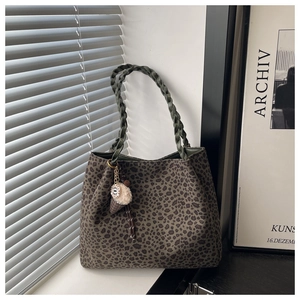 Detail of leopard print tote bag with braided handle and cute ice cream charm detail
