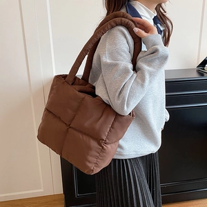 Brown quilted puffer tote bag for women with padded shoulder straps and square stitching