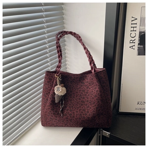 Detail of dark red leopard print tote with woven handles and ice cream charm