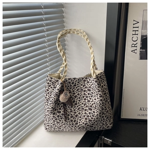 Detailed leopard print tote with woven rope handles and ice cream charm on a windowsill