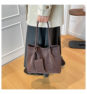 Detail of dark brown faux suede tote bag with matching mini pouch and slim shoulder strap