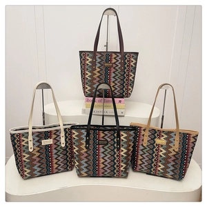 Detailed view of four colorful bohemian zigzag pattern tote bags with slim leather straps