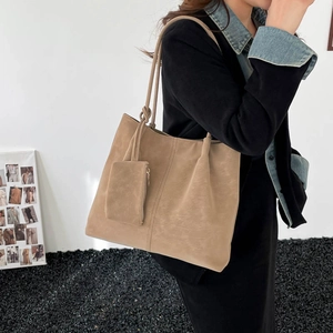 Large khaki faux suede tote bag for women with matching inner pouch on minimalist background