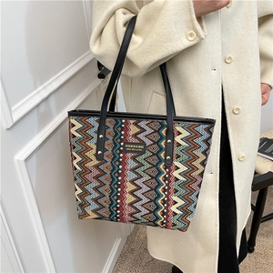 Ethnic bohemian tote bag with vibrant zigzag patterns and black shoulder straps