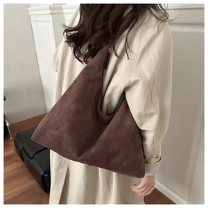 Close-up of the vintage brown suede hobo bag showing its large capacity and soft texture