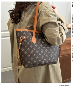 Detail of vintage monogram tote bag with brown leather trim and side drawstring detail