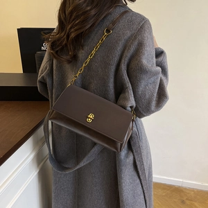 Classic brown leather shoulder bag with gold metal buckle and chain strap for women