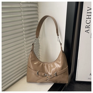 Detail of khaki leather underarm bag featuring silver buckle and glossy finish