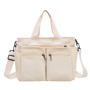 Minimalist nylon tote bag in cream white with dual front pockets and adjustable strap