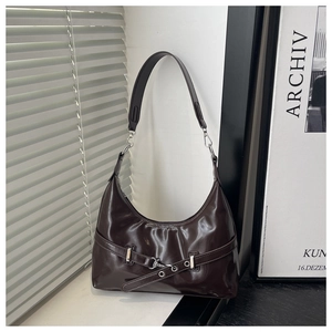 Macro detail of dark coffee glossy leather hobo bag with silver buckle and hardware