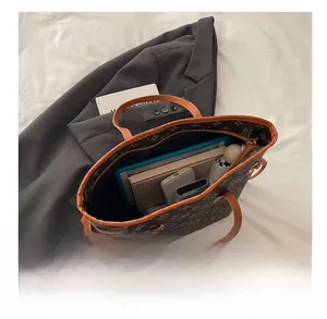 Top view of large vintage tote bag showing its spacious interior with tablet and umbrella