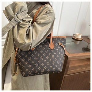 Classic brown monogram tote bag with vintage print shown in side-view lifestyle setting
