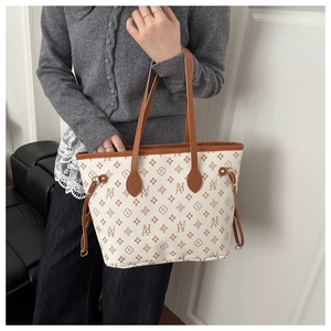 Detailed view of monogram print tote with side drawstrings and premium leather handles