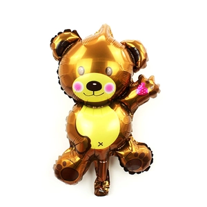 Detail of bear foil balloon in brown gold with pink heart for birthday decoration