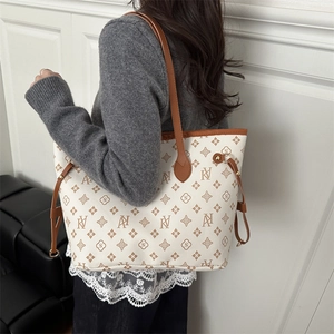 Women's monogram tote bag in cream and brown leather with spacious shoulder straps