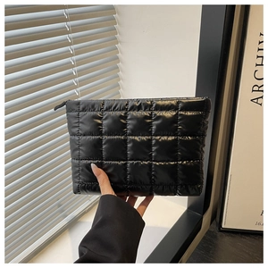 Close-up of black quilted puffer cosmetic bag with premium lightweight padded nylon fabric