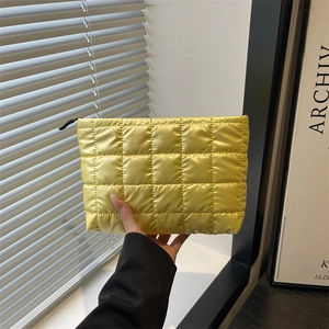 Quilted yellow padded makeup bag with high-capacity design and sleek zipper closure